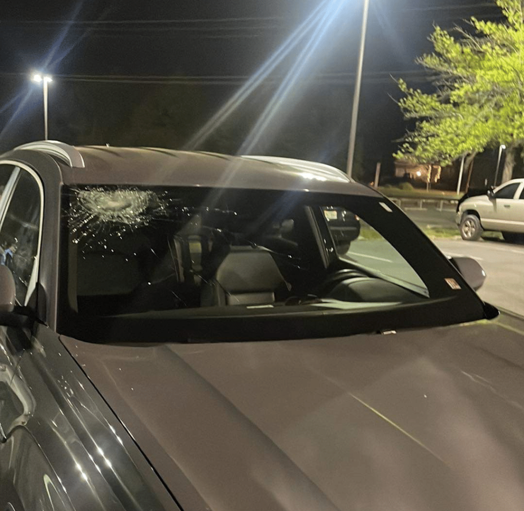 Home run to Remember image of damage to windshield from a softball.
