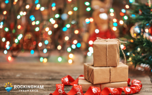 three brown boxes next to Christmas tree